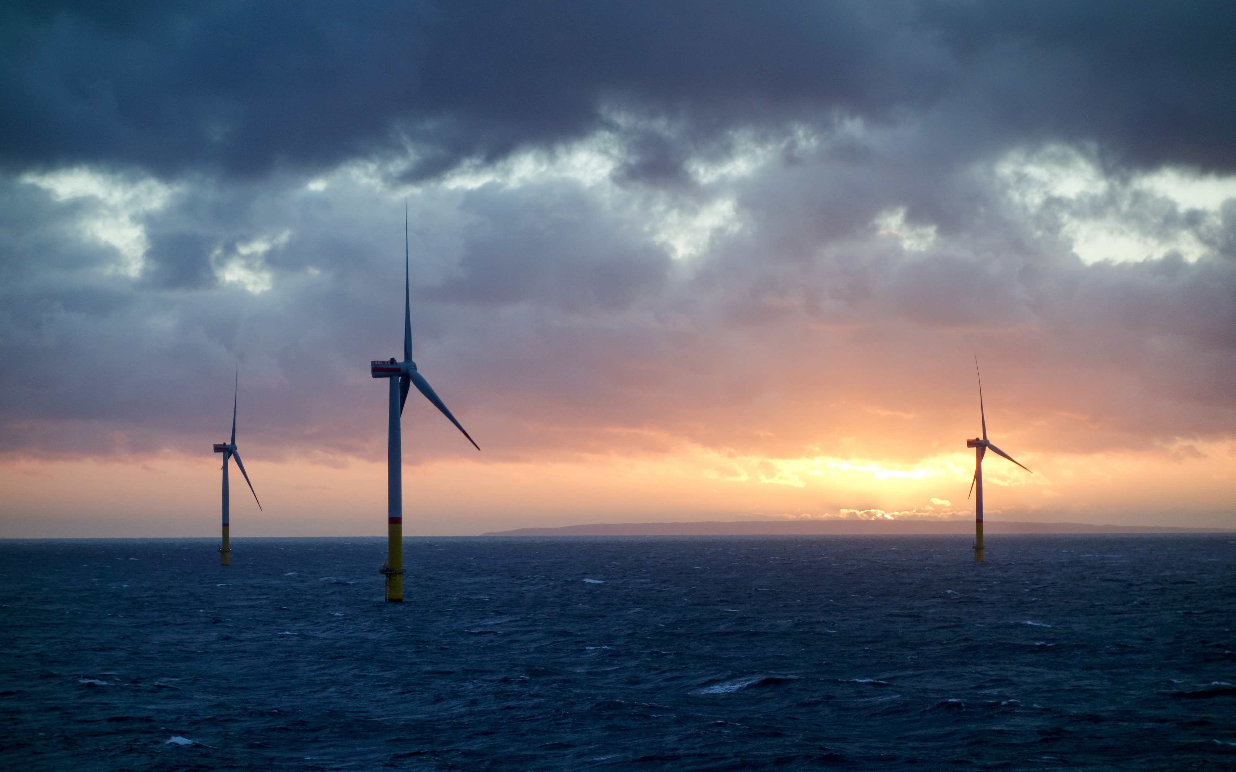 Offshore wind-farm in sunset and clouds