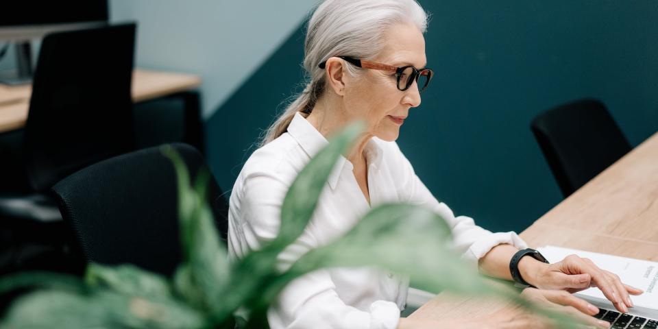 Elderly lady working on laptop