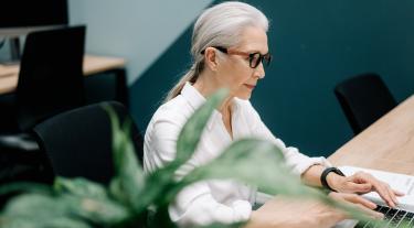 Elderly lady working on laptop